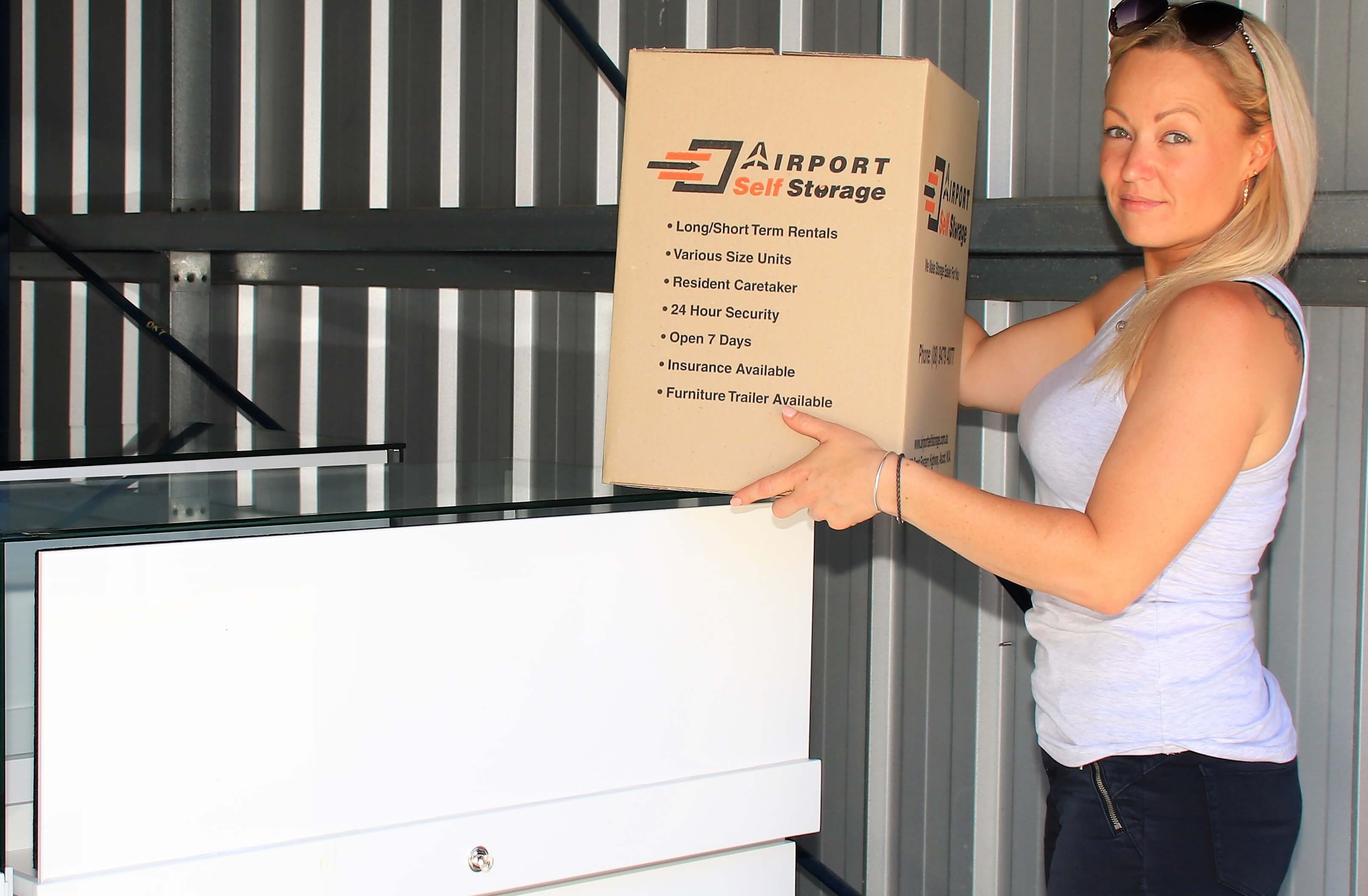 woman holding airport self storage box