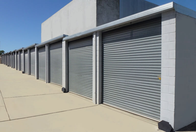 row of bark blue storage sheds